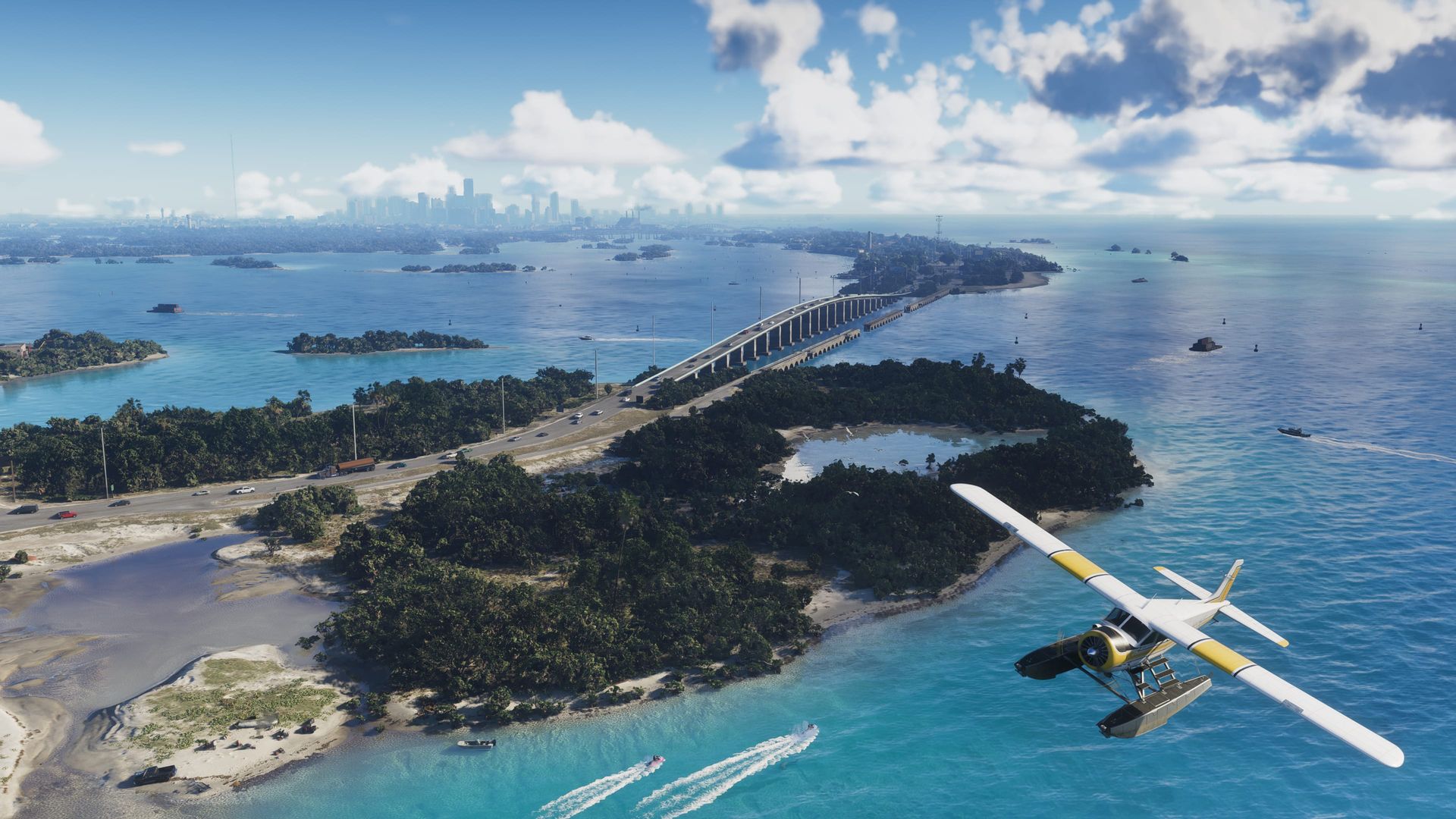 Aerial view of islands, a long bridge and a seaplane over turquoise water