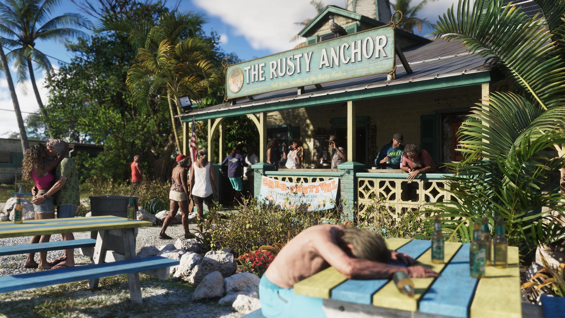 Eine Bar am Wasser namens The Rusty Anchor, Gäste an Picknicktischen davor