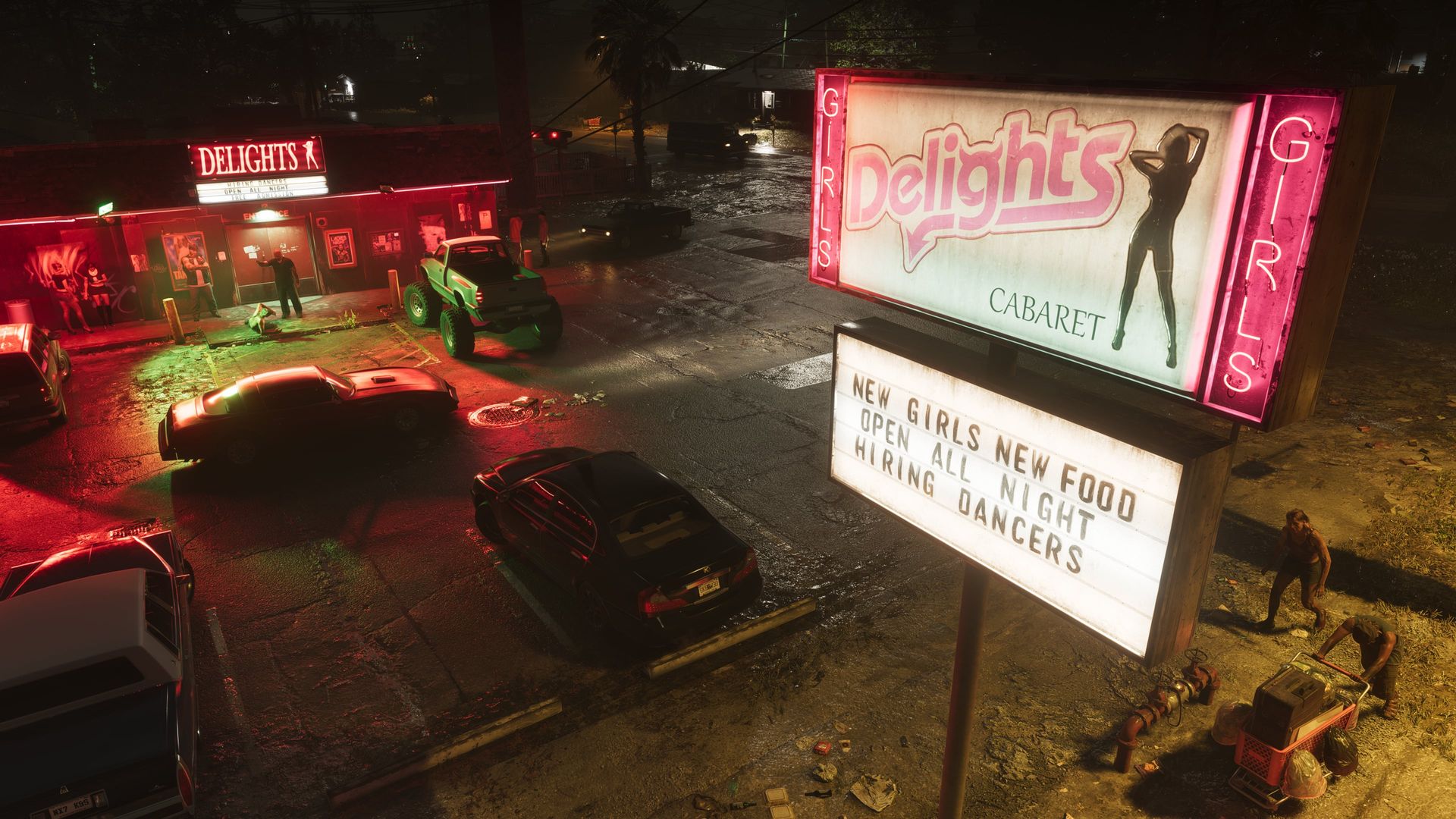 Das beleuchtete Straßenschild eines Cabarets neben einem Parkplatz bei Nacht