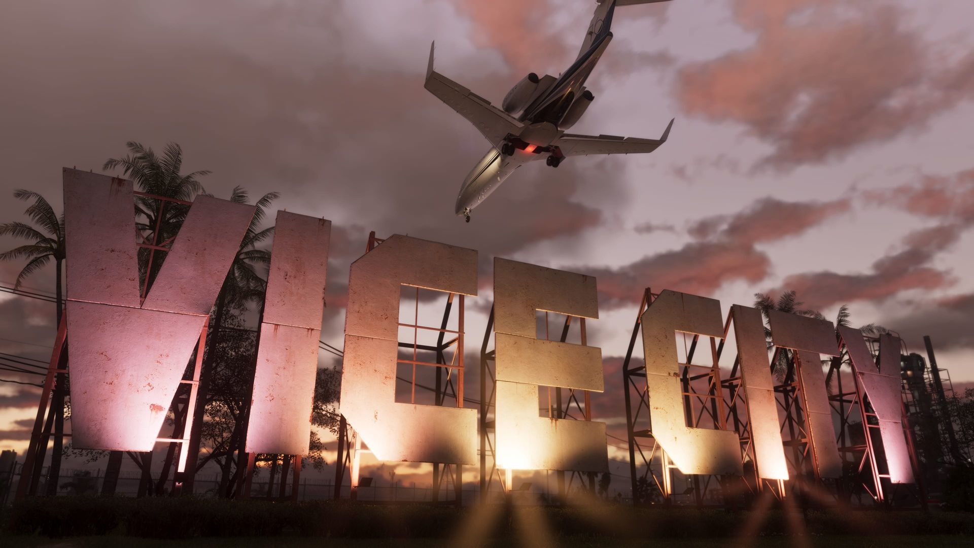 Riesige Buchstaben „Vice City“, beleuchtet in der Dämmerung, darüber fliegt ein kleiner Jet