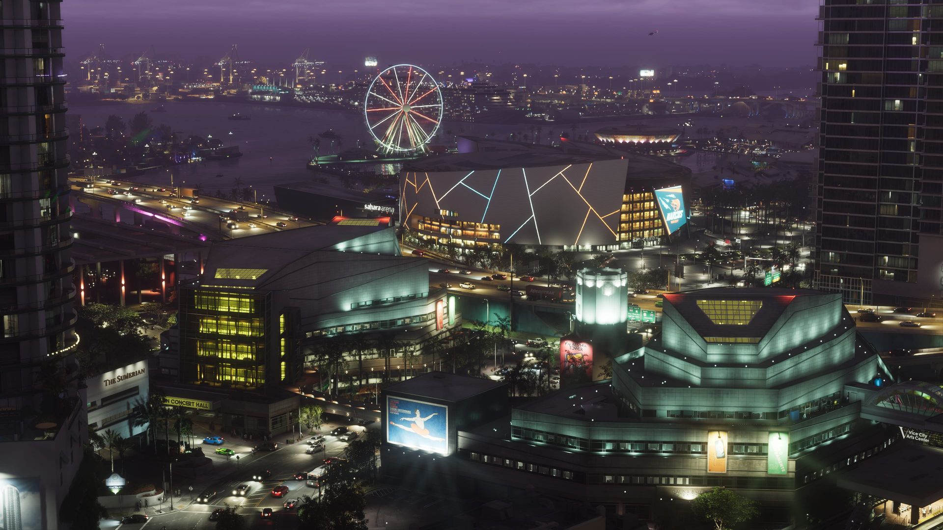 Die Stadt bei Nacht von oben, mit beleuchtetem Riesenrad an der Uferpromenade