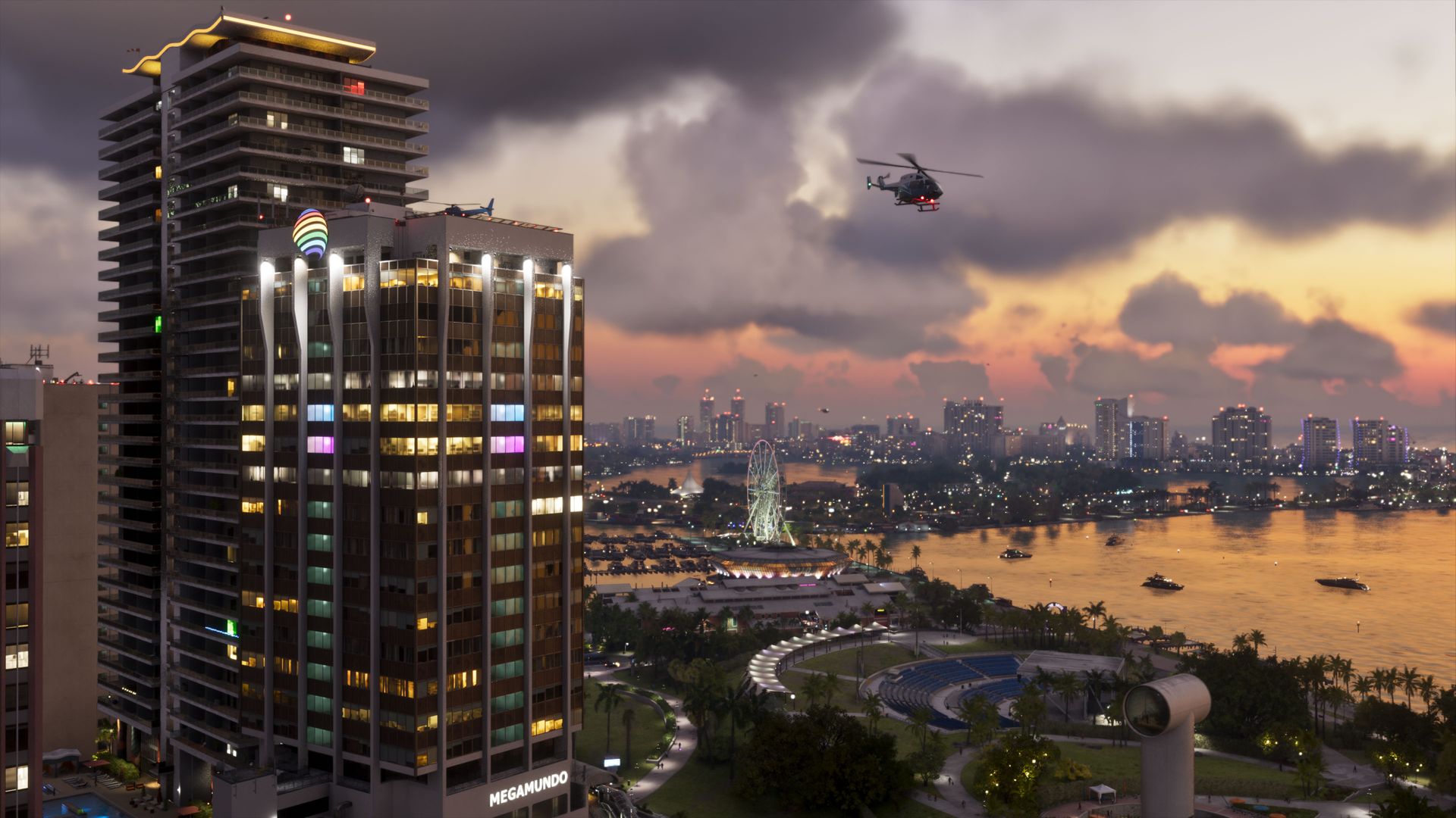 A high-rise tower in the foreground and the Vice City skyline across the bay at sunset, a helicopter overhead